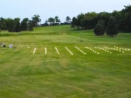 Light show drones staged in a grid formation on the field before launch