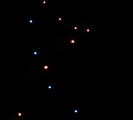 Spiral drone light show formation entertaining a venue audience