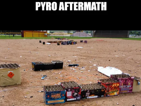 Spent firework shells and debris left across a field after a pyrotechnics show